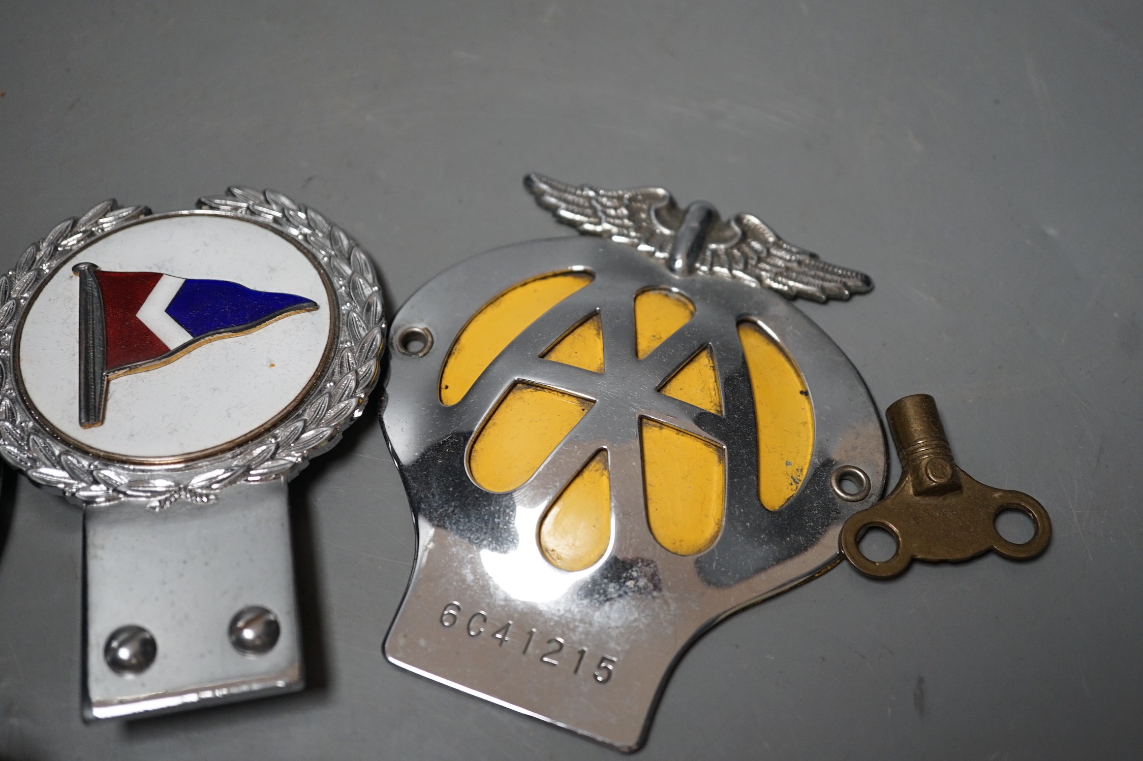 A British Automobile Racing Club car badge, an AA badge and one other